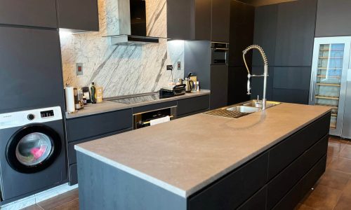 A modern kitchen featuring a sink, showcasing sleek wrapping design and work